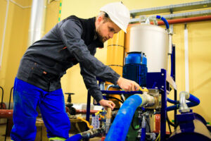 commercial septic engineer working on pipes